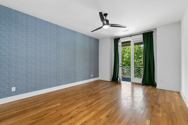 empty room featuring hardwood / wood-style floors and ceiling fan