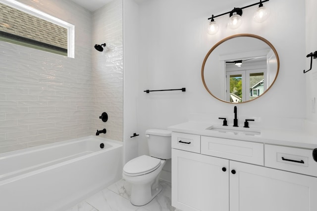 full bathroom with vanity, toilet, and tiled shower / bath combo