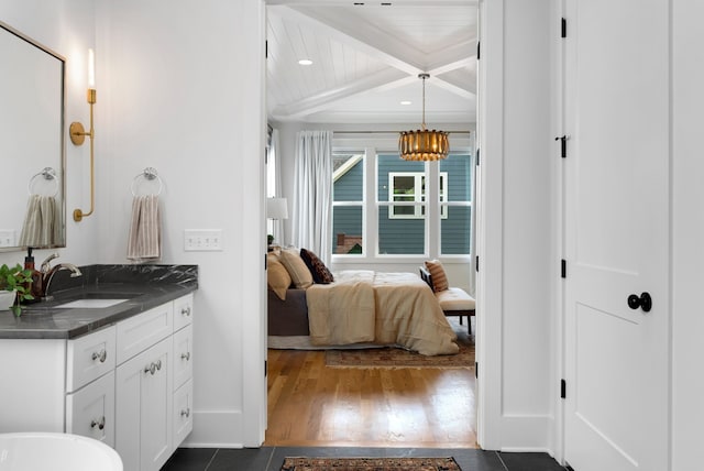 bathroom with wood ceiling, vanity, wood-type flooring, an inviting chandelier, and beamed ceiling