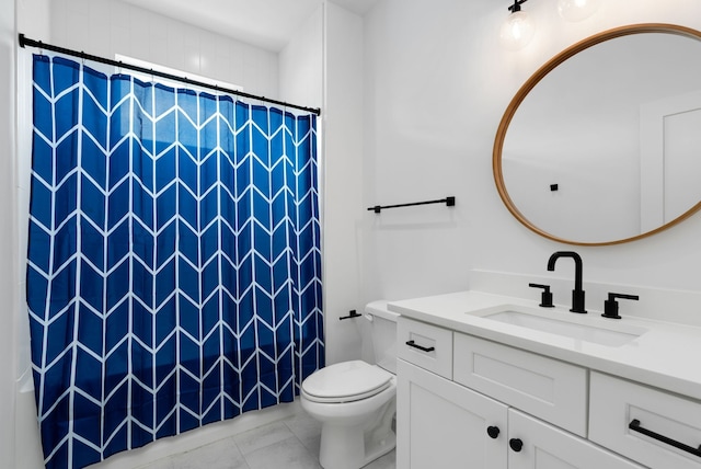 bathroom with vanity, toilet, and walk in shower