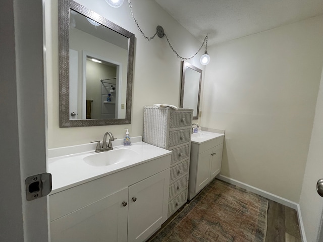 bathroom featuring a textured ceiling, vanity, and hardwood / wood-style flooring