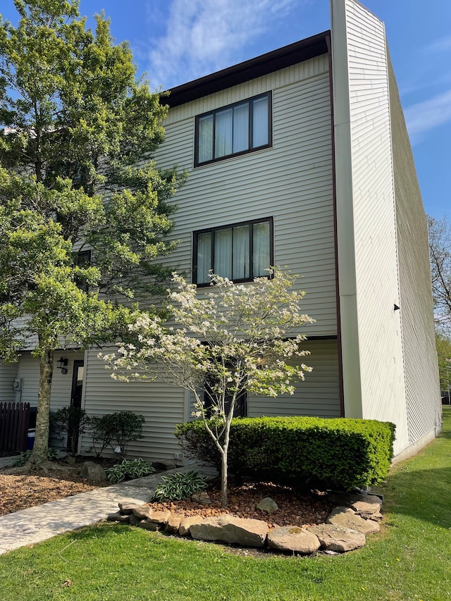 view of property exterior with a yard