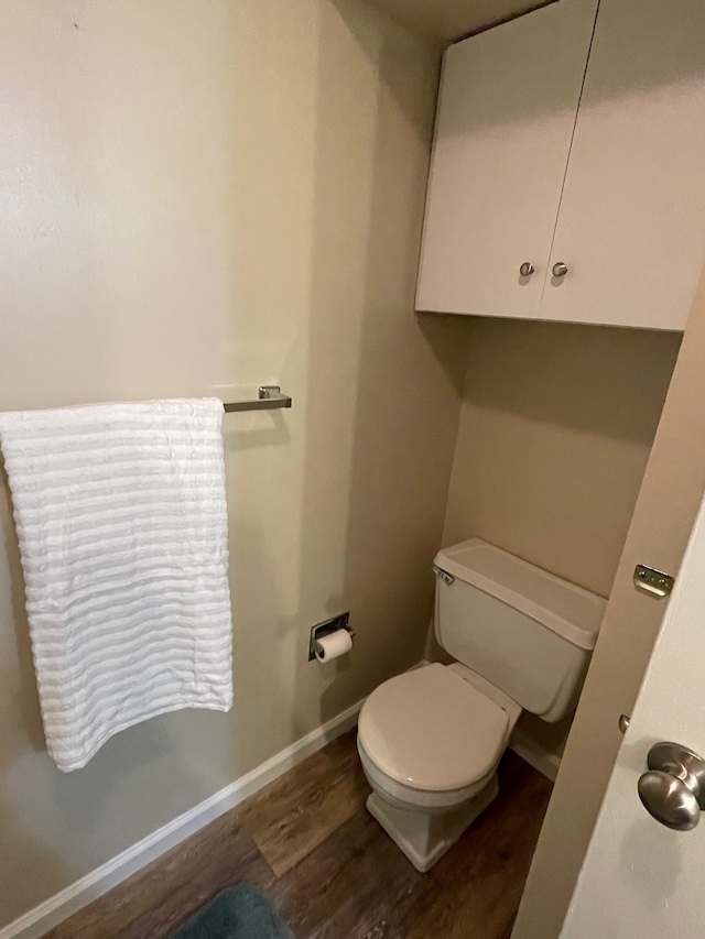 bathroom featuring toilet and hardwood / wood-style flooring