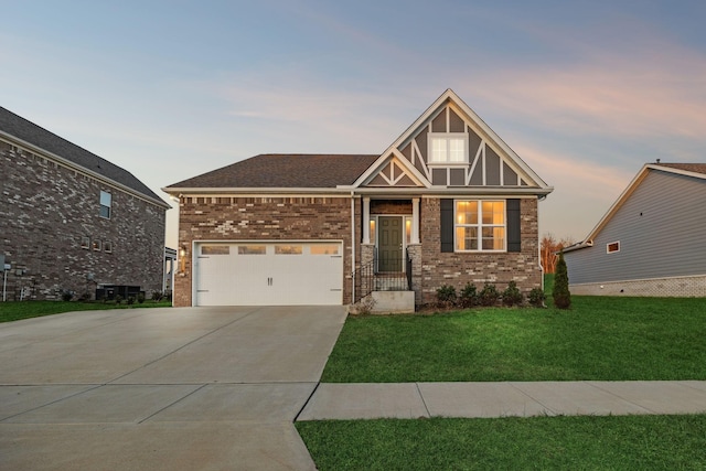 view of front of home featuring a yard and a garage