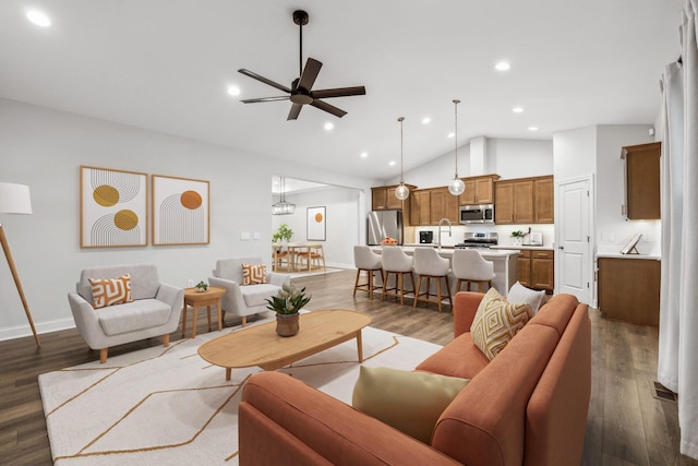 living room with dark wood-type flooring, ceiling fan, and vaulted ceiling