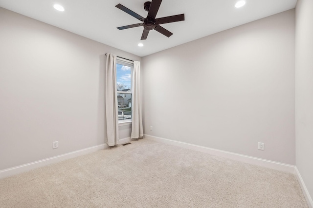 unfurnished room featuring light colored carpet and ceiling fan