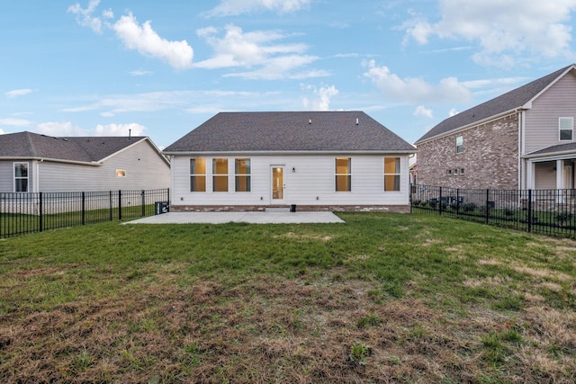 rear view of property featuring a yard and a patio area