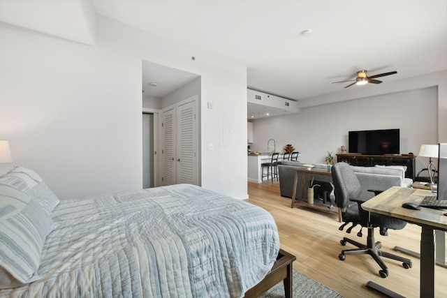 bedroom featuring a closet, light hardwood / wood-style floors, and ceiling fan