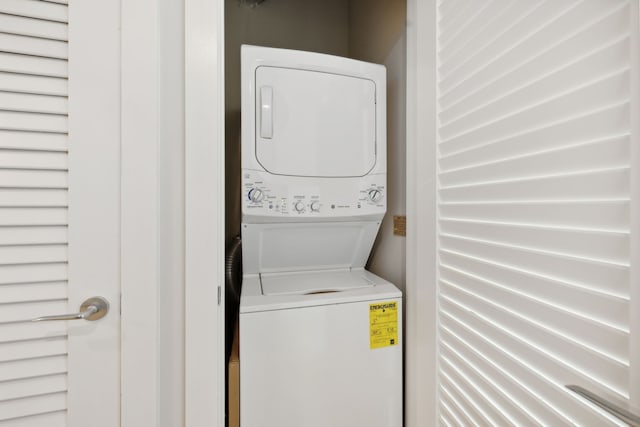 washroom featuring stacked washer / dryer