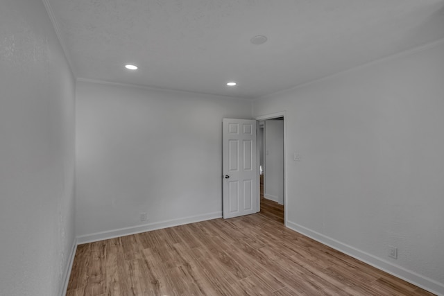 unfurnished room featuring light hardwood / wood-style flooring and crown molding