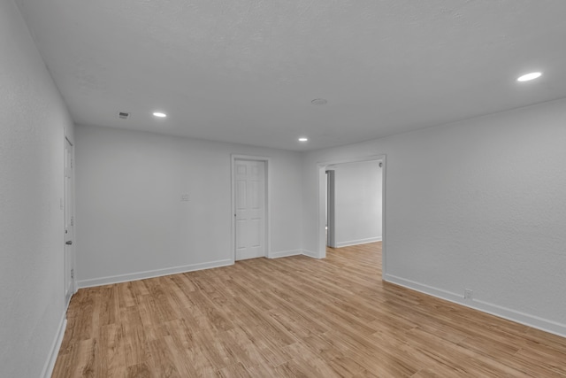 empty room with light hardwood / wood-style floors