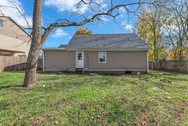 rear view of house with a lawn