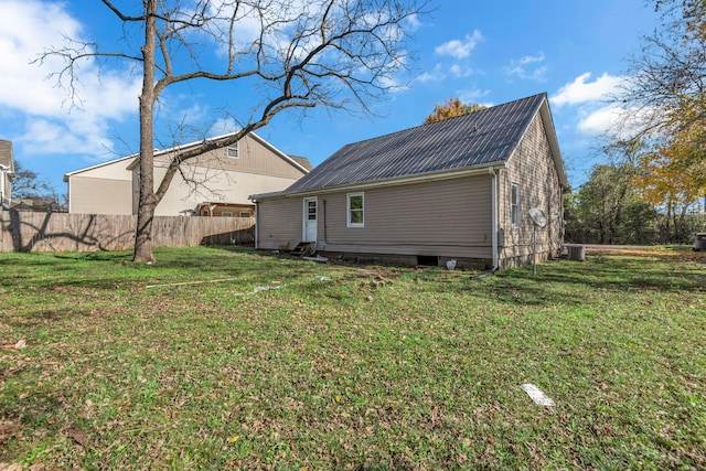 back of property featuring a yard