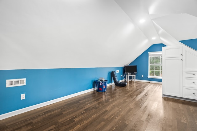 bonus room featuring dark hardwood / wood-style flooring and lofted ceiling