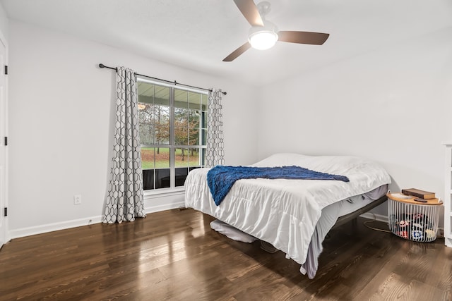 bedroom with ceiling fan and dark hardwood / wood-style flooring