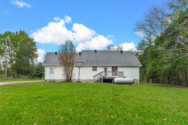 back of property featuring a yard and a deck