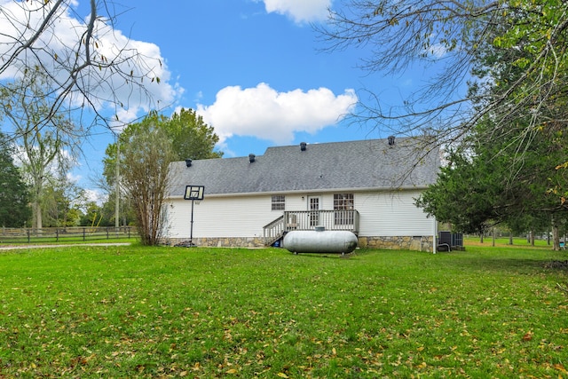 back of house with a lawn and a deck