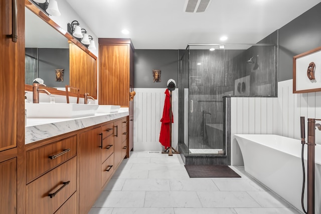 bathroom with vanity and independent shower and bath