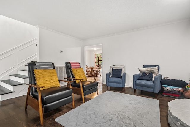 living area featuring dark hardwood / wood-style floors and ornamental molding