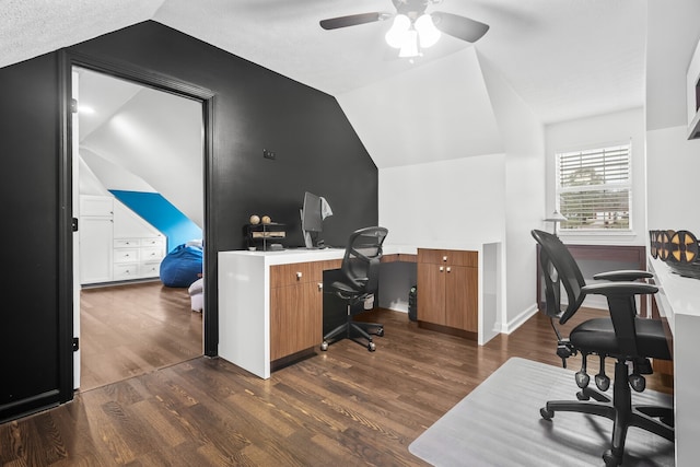 office area featuring a textured ceiling, lofted ceiling, ceiling fan, and dark wood-type flooring