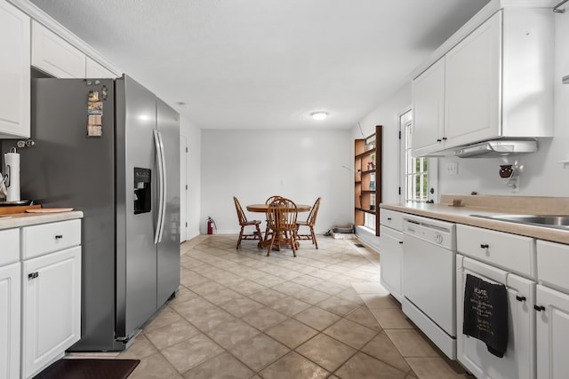 kitchen with white cabinetry, dishwasher, light tile patterned floors, and stainless steel fridge with ice dispenser