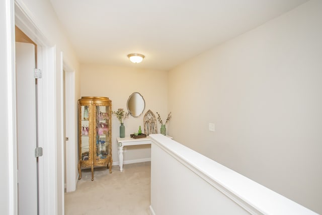 hallway featuring light carpet