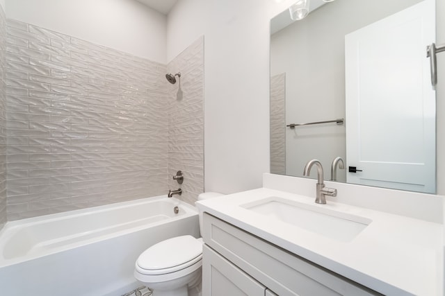 full bathroom with vanity, toilet, and tiled shower / bath