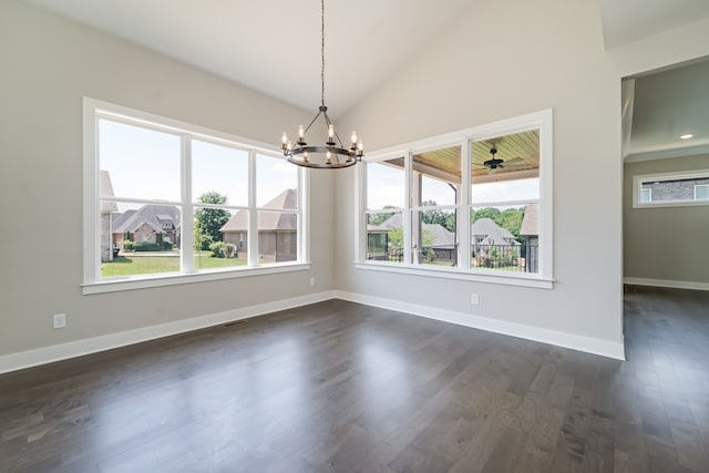 unfurnished dining area with dark hardwood / wood-style flooring, vaulted ceiling, and an inviting chandelier