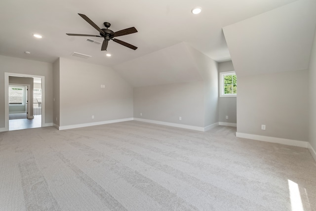 additional living space featuring ceiling fan, lofted ceiling, and light carpet