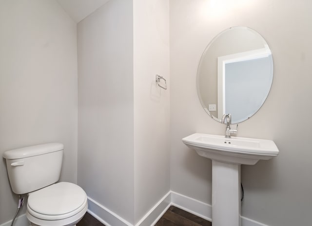 bathroom featuring hardwood / wood-style floors and toilet