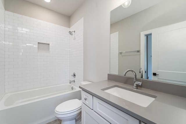 full bathroom with vanity, toilet, and tiled shower / bath