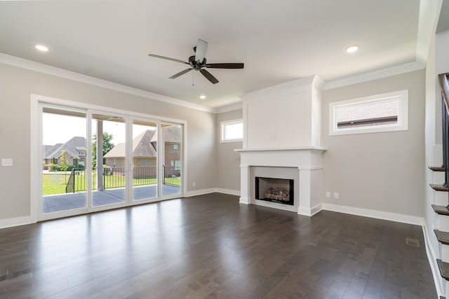 unfurnished living room with ornamental molding, dark hardwood / wood-style flooring, and plenty of natural light