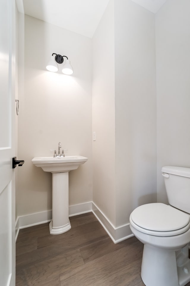 bathroom featuring toilet and hardwood / wood-style flooring