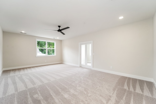 spare room with light carpet and ceiling fan