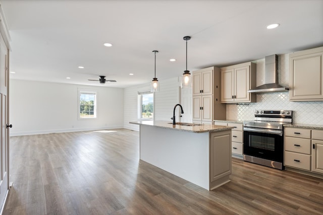 2105 52e Hwy, Portland, TN 37148 - kitchen featuring stainless steel electric stove, wall chimney exhaust hood, a sink, cream cabinets, and dark wood-style flooring