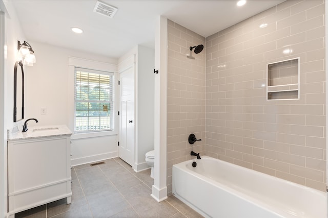 full bathroom with toilet, vanity, tile patterned floors, and tiled shower / bath