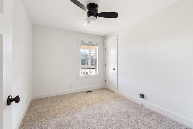 unfurnished room with ceiling fan and light carpet