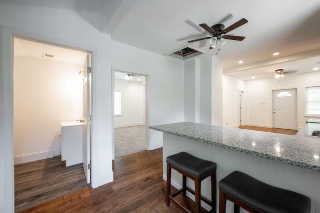800 Tunnel Blvd, Chattanooga, TN 37406 - kitchen with a ceiling fan, dark wood-type flooring, light stone countertops, a breakfast bar, and baseboards