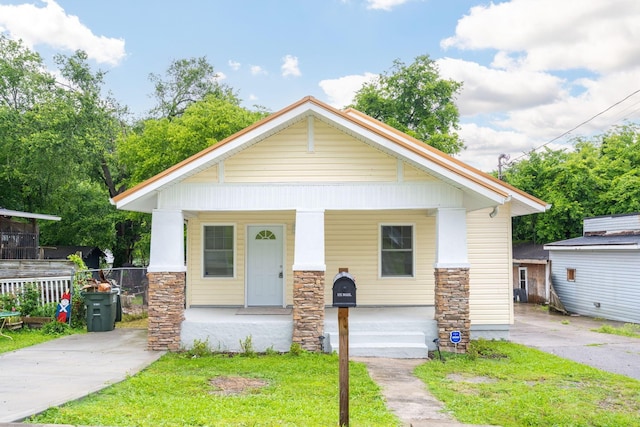 800 Tunnel Blvd, Chattanooga, TN 37406 - view of front of home featuring covered porch, stone siding, and a front lawn
