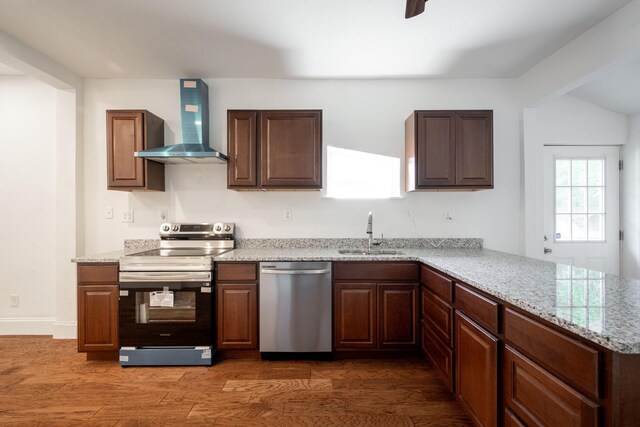 800 Tunnel Blvd, Chattanooga, TN 37406 - kitchen featuring stainless steel appliances, wall chimney exhaust hood, a sink, dark wood-style floors, and a peninsula
