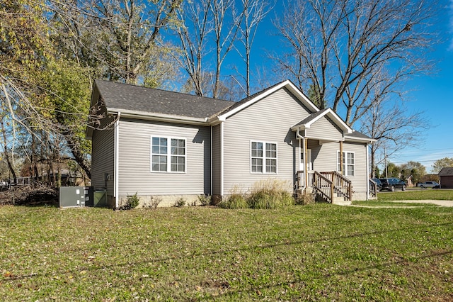 exterior space featuring a front yard and central AC unit