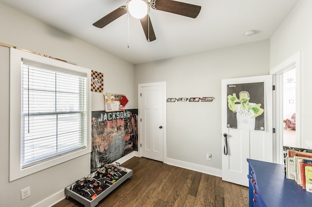 interior space with ceiling fan and dark hardwood / wood-style flooring