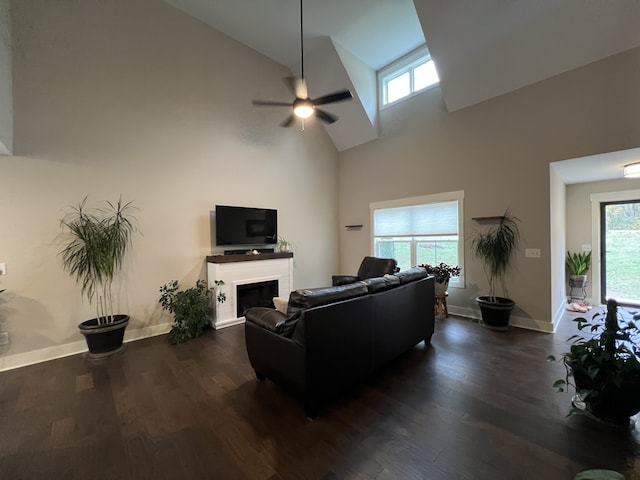 living room featuring dark hardwood / wood-style flooring, high vaulted ceiling, and ceiling fan