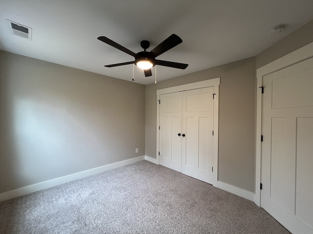 unfurnished bedroom featuring ceiling fan, carpet floors, and a closet