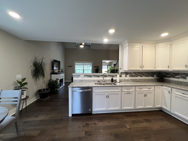 kitchen featuring white cabinetry, dishwasher, light stone countertops, sink, and dark hardwood / wood-style flooring