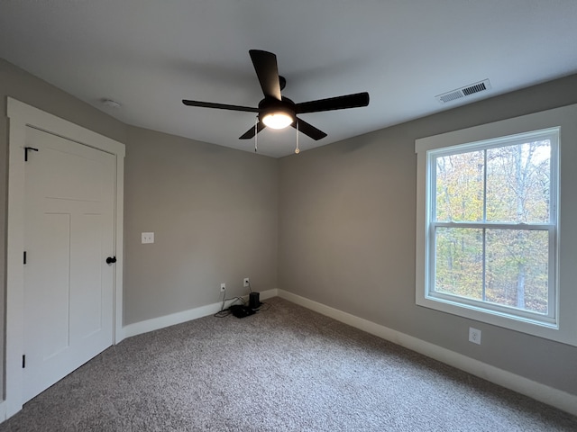 empty room featuring carpet and ceiling fan