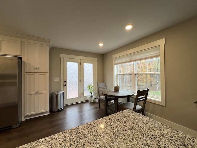 dining room with dark hardwood / wood-style floors and plenty of natural light