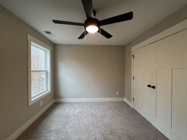 unfurnished bedroom featuring ceiling fan and carpet floors