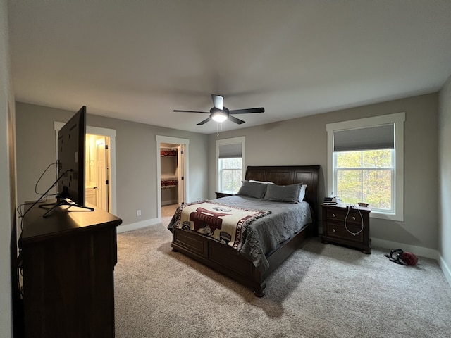 carpeted bedroom featuring ensuite bathroom and ceiling fan