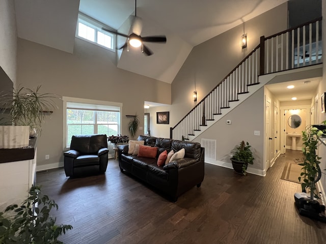 living room with high vaulted ceiling, ceiling fan, and dark wood-type flooring